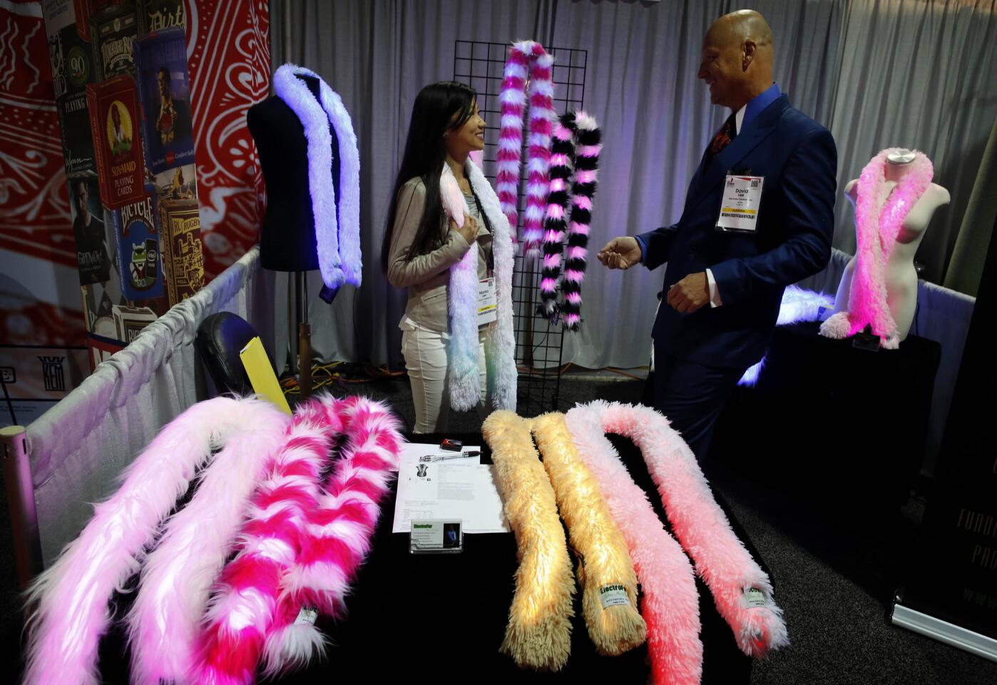David and MoMo Lee show off Electrofur boas at the Advertising Specialty Institute's promotional products convention at the Long Beach Convention Center.