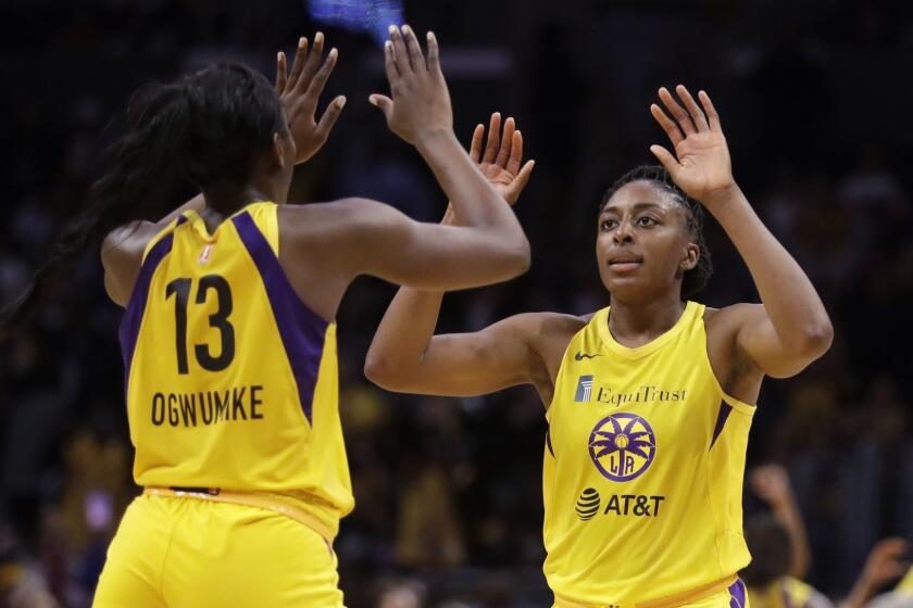 FILE - In this Friday, May 31, 2019, file photo, Los Angeles Sparks' Chiney Ogwumike (13) and her sister Nneka Ogwumike celebrate after a win over the Connecticut Sun in a WNBA basketball game in Los Angeles. Chiney Ogwumike doesnt know what kind of reception shell get from the Connecticut Sun fans when her new team, the Los Angeles Sparks, visit on Thursday. Shell understand if the fans boo her after she asked for a trade to Los Angeles in the offseason. Meanwhile, shes having a great time in Los Angeles with her new team and her sister Nneka. AP Photo/Marcio Jose Sanchez, File)