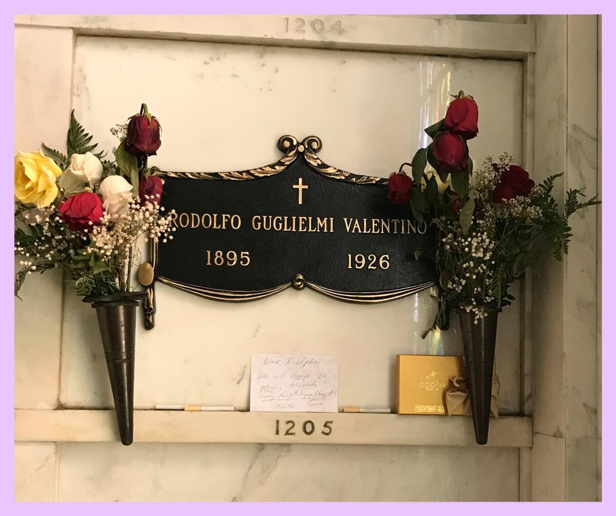 A grave marker that reads Rodolfo Guglielmi Valentino flanked by flowers