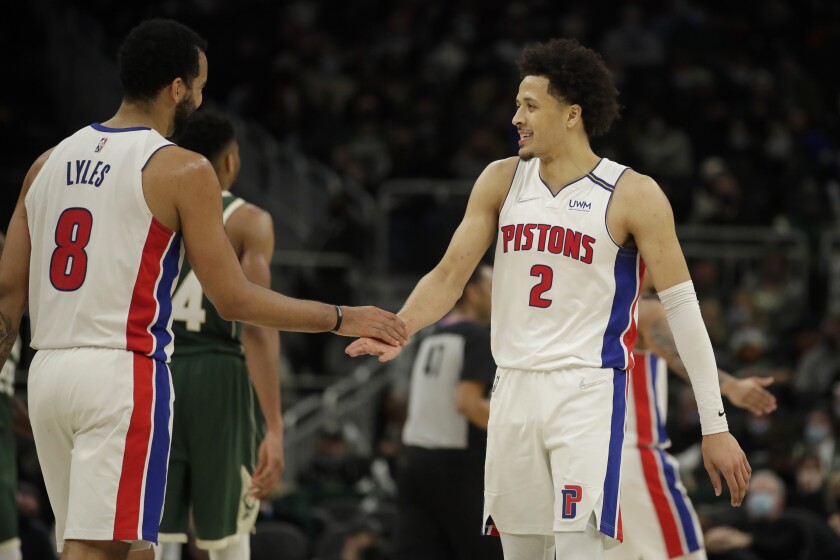 Detroit Pistons' Cade Cunningham (2) smiles with Trey Lyles (8) during the second half of an NBA basketball game against the Milwaukee Bucks, Monday, Jan. 3, 2022, in Milwaukee. (AP Photo/Aaron Gash)