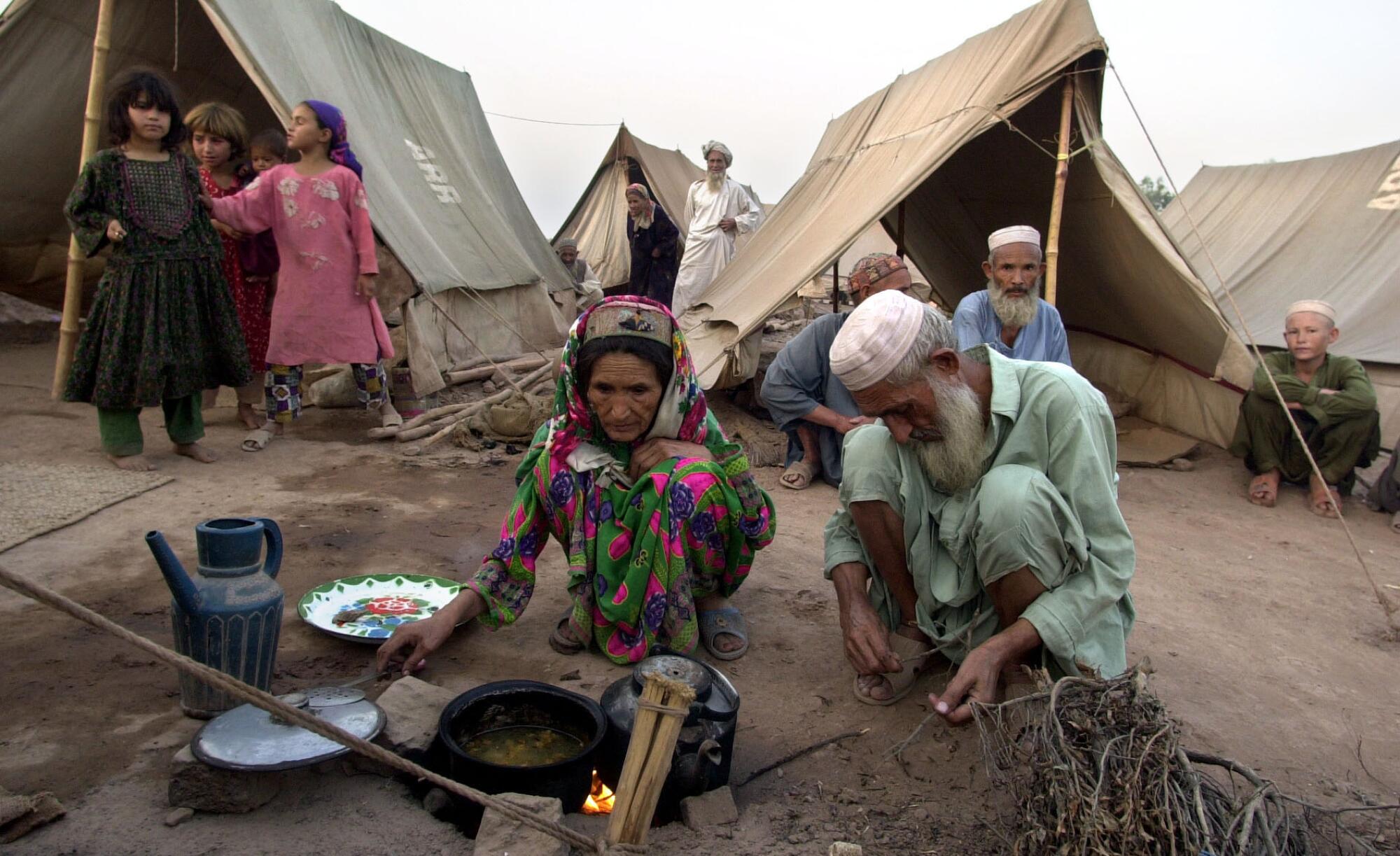 Afghan refugees at cook at Jalozai refugee camp near Peshawar, Pakistan on Sept. 29, 2001.