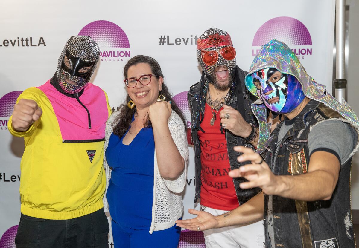 Allegra Padilla, second from left, executive director of Levitt Pavilion Los Angeles, poses with El Conjunto Nueva Ola
