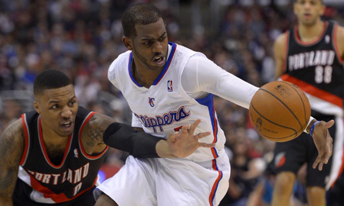 Clippers point guard Chris Paul, right, and Portland Trail Blazers guard Damian Lillard battle for a loose ball during the Clippers' win Feb. 12. Paul's on-court intensity makes him a valuable asset for the Clippers, as long as he remains healthy.