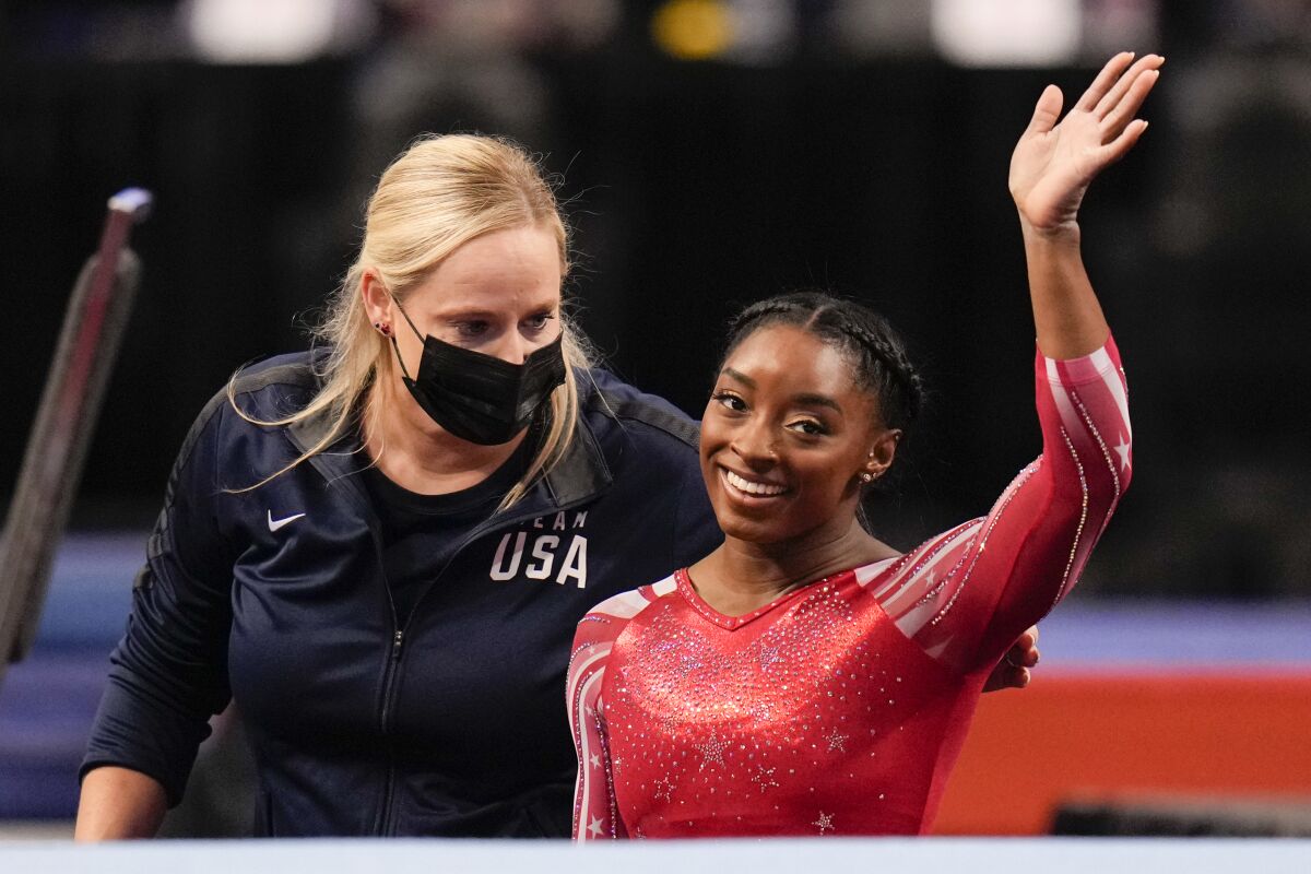 Simone Biles waves after competing in the floor exercise during the women's U.S. Olympic Gymnastics Trials Sunday, June 27, 2021, in St. Louis. (AP Photo/Jeff Roberson)