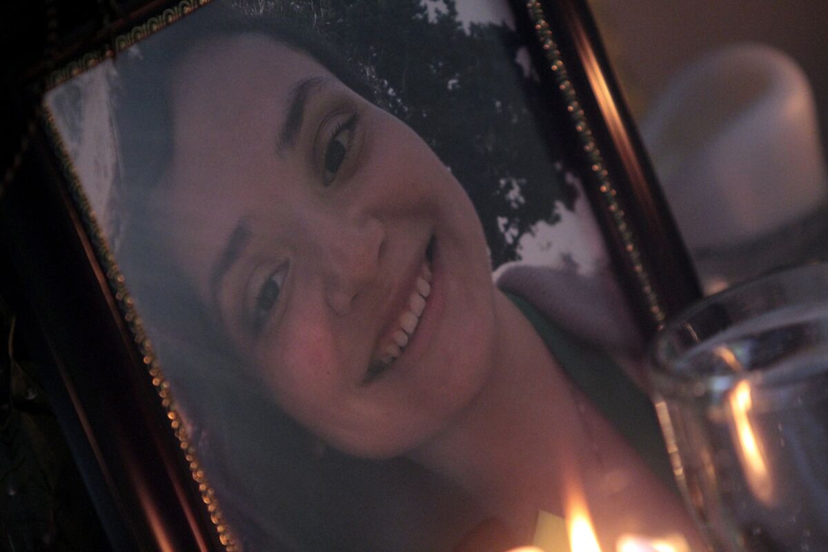 A candle burns next to a family photo of Jennifer Bonilla, the Dorsey High senior who was killed in last week's bus crash in Orland, Calif.