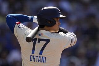 Los Angeles Dodgers' Shohei Ohtani bats during the first inning of a baseball game.