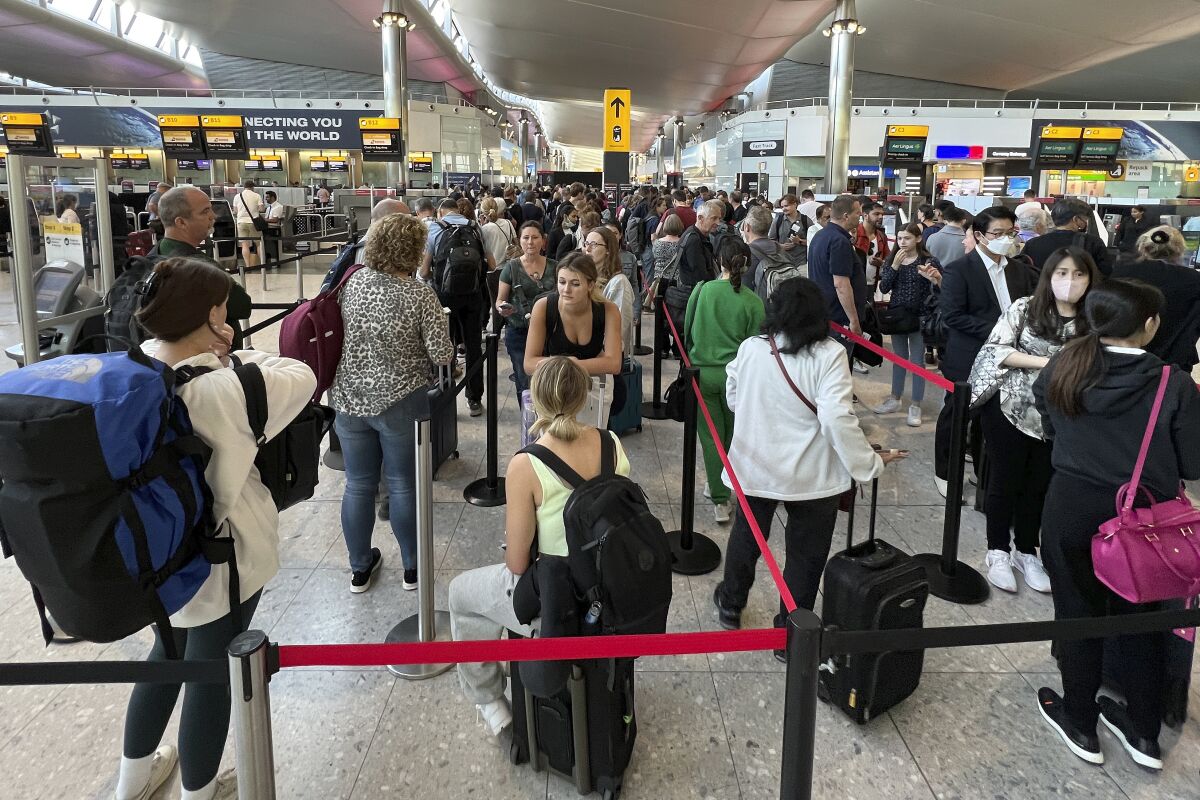 Passengers queuing at Heathrow Airport in London