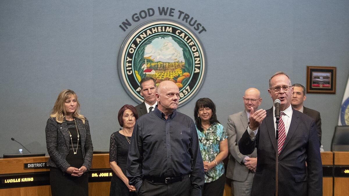 Grant Hier, center, Anaheim’s inaugural poet laureate, is introduced by Mayor Tom Tait during a City Coucil meeting on May 15.