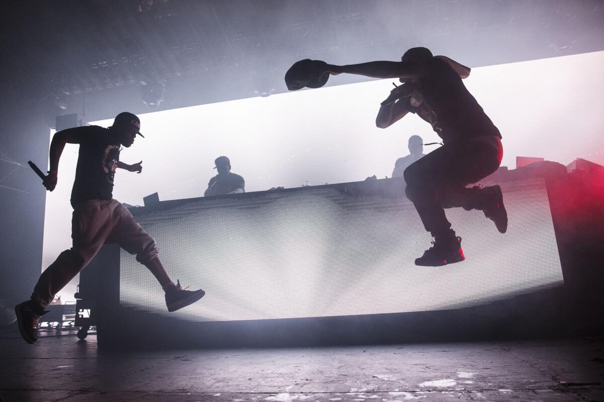 The silhouettes of Method Man and Redman jumping in the air while performing.