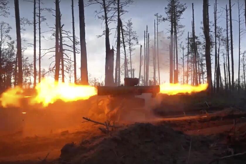 In this handout photo taken from video released by Russian Defense Ministry Press Service on Thursday, May 25, 2023, a Russian army soldier fires a Fagot anti-tank missile system toward Ukrainian position at an undisclosed location. (Russian Defense Ministry Press Service photo via AP)