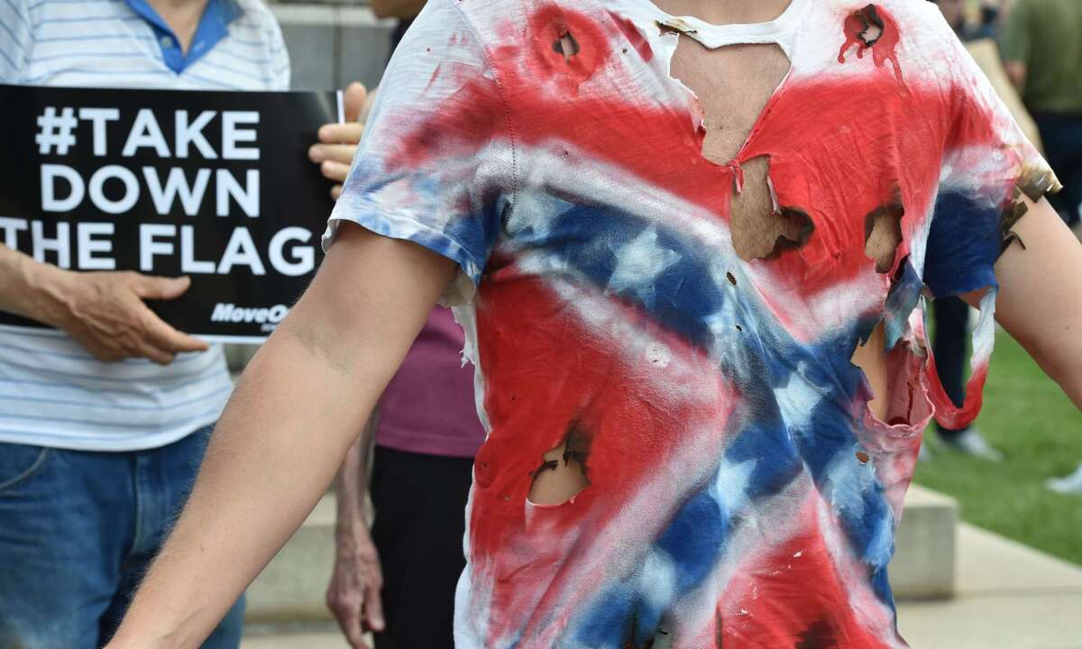 A man wears a T-shirt representing the Confederate flag during a protest in Columbia, S.C., on Saturday.