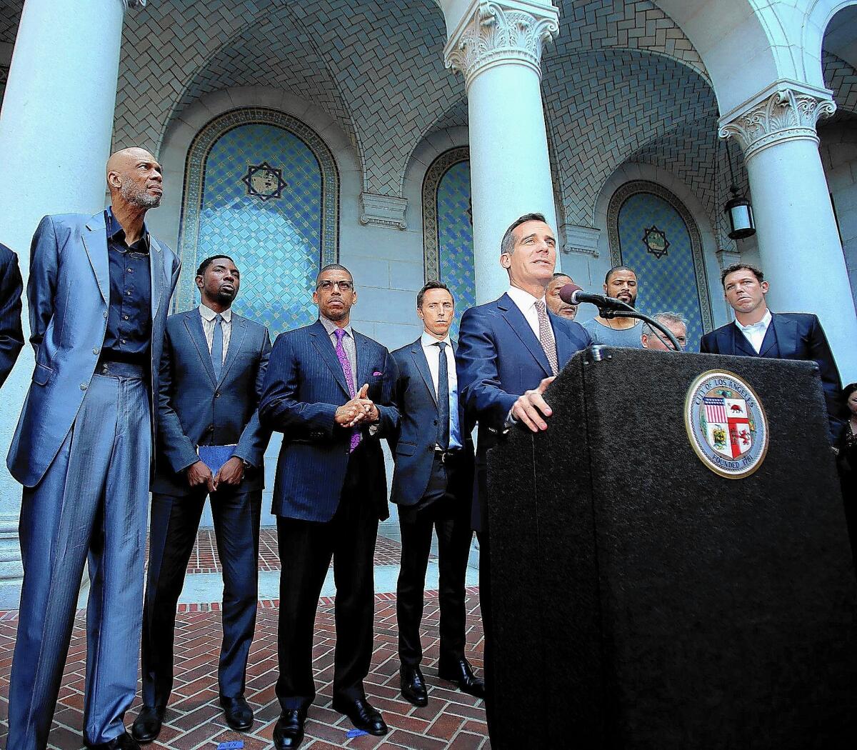 L.A. Mayor Eric Garcetti, flanked by former and current professional basketball players, holds a news conference on the steps of City Hall to talk about the lifetime ban imposed by the NBA on L.A. Clippers owner Donald Sterling.