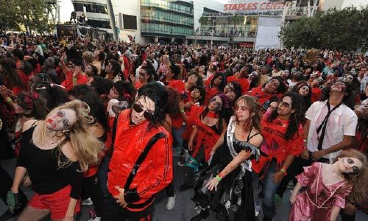 Thousands of amateur dancers in full zombie makeup gathered at L.A. Live on Oct. 24 for Thrill The World, a worldwide attempt to set the record for the number of people simultaneously performing the zombie dance from Michael Jackson's iconic "Thriller" video.