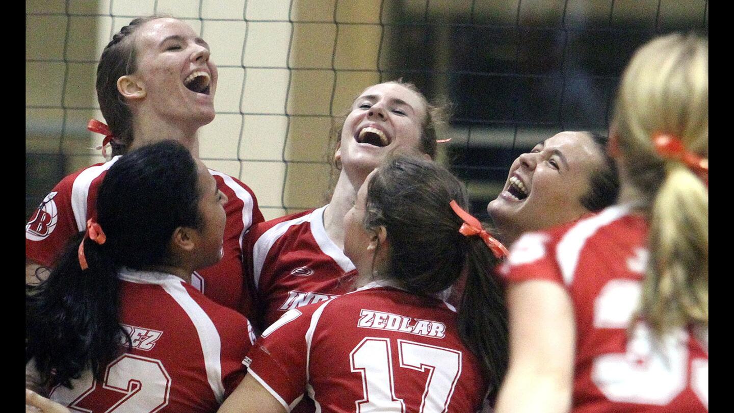 Burroughs' Danielle Ryan, Caleigh Paster, and Jessica Rury are all smiles after defeating Bonita in a second round CIF Division 2A girls volleyball match at Burroughs High School on Thursday, November 12, 2015. Burroughs won the match 3-0.