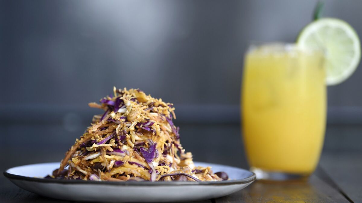 Asinan kelapa is a refreshing Indonesian slaw made with cabbage, mango and a sweet and tangy dressing topped with toasted coconut-chili flakes.