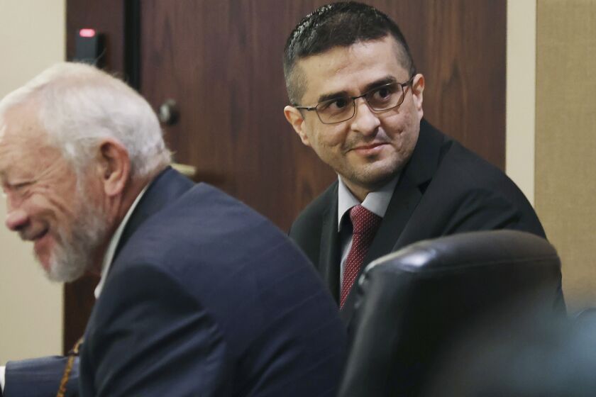 FILE - Capital murder defendant and former U.S. Border Patrol Juan David Ortiz looks around the courtroom before the start of the first day of the trial before Webb County State District Court Judge Oscar J. Hale, on Nov. 28, 2022. Jurors in Ortiz's capital murder trial have heard him confess in a taped interview in early December 2022 to killing four sex workers in South Texas. (Jerry Lara/The San Antonio Express-News via AP, File)