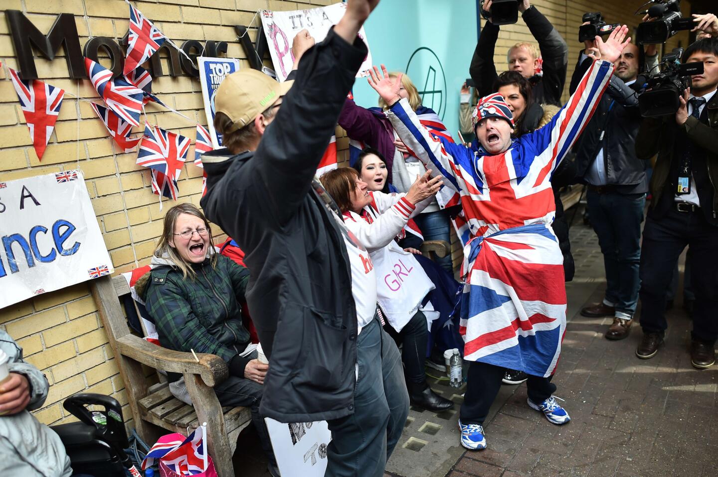 Royal fans celebrate outside St. Mary's hospital in central London after hearing that the Duchess of Cambridge had given birth to a girl.