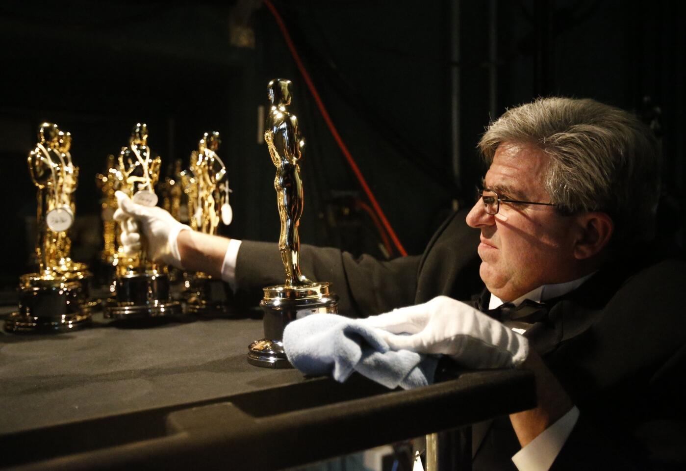 Oscar statuettes get the white-glove treatment.
