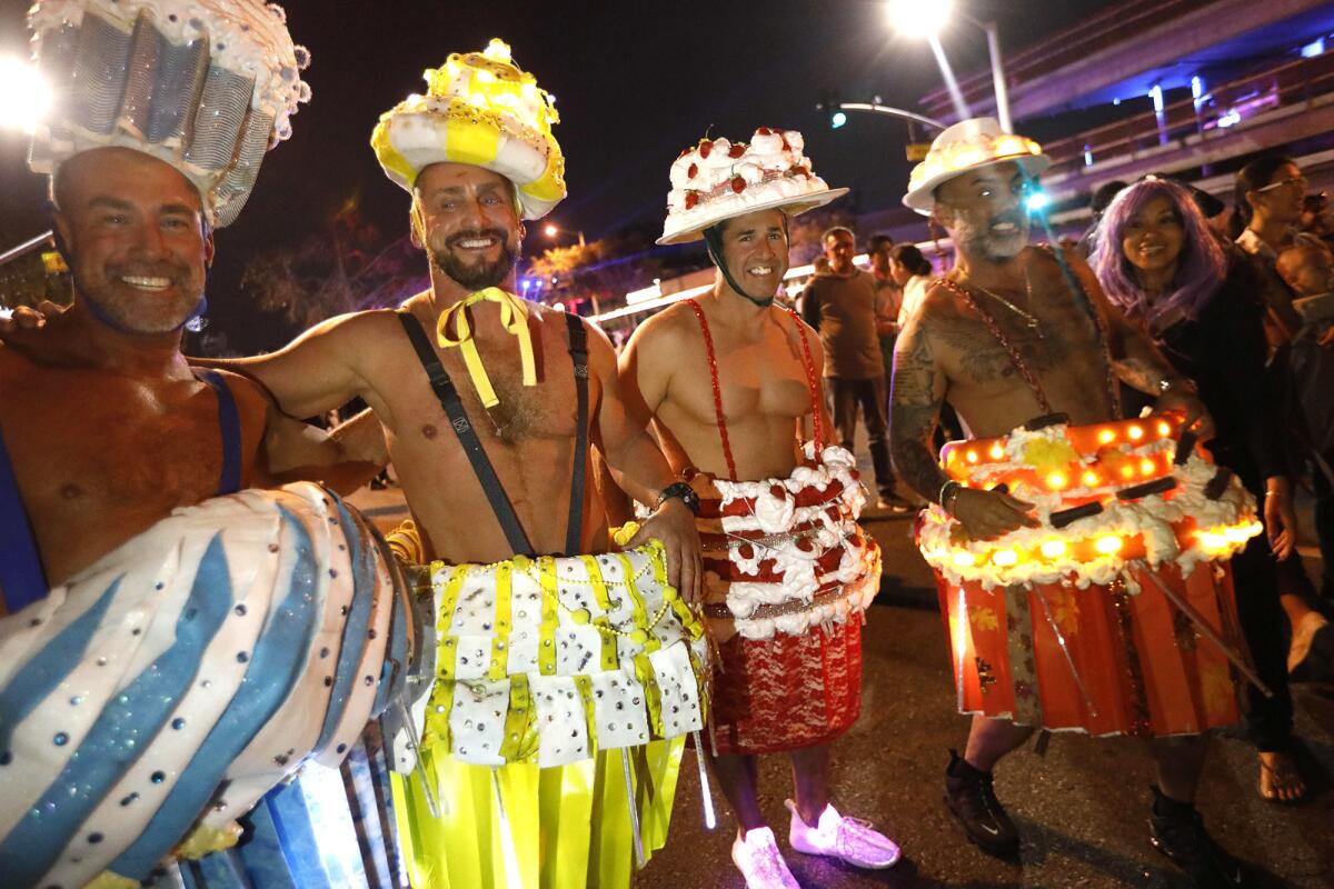 Rob Peter, from left, Tommy Cleney, Curtis Hutchinson and Edward Roque, dress as human cupcakes while joining the thousands of costumed revelers at the annual Halloween Carnaval..