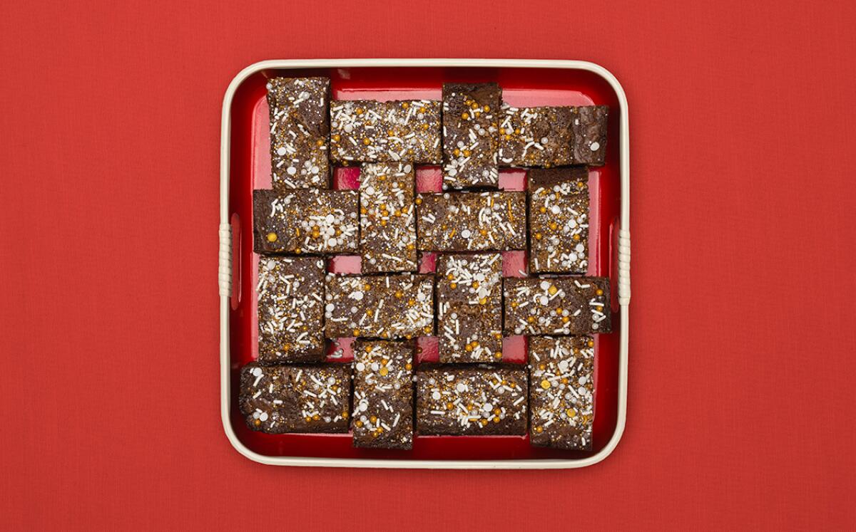 Brownies are seen from above on a red decorative tray.