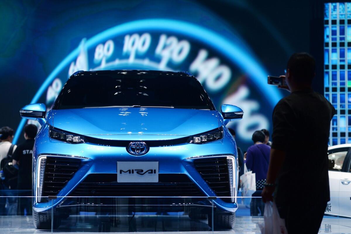 A man takes a photo in front of a Toyota Mirai during the 16th Shanghai International Automobile Industry Exhibition in Shanghai on April 22, 2015. La Cañada Flintridge’s first hydrogen cell station at the Foothill Boulevard ARCO station could soon be up and running, just as Toyota readies plans to roll out its first line of the hydrogen-powered vehicles in October.