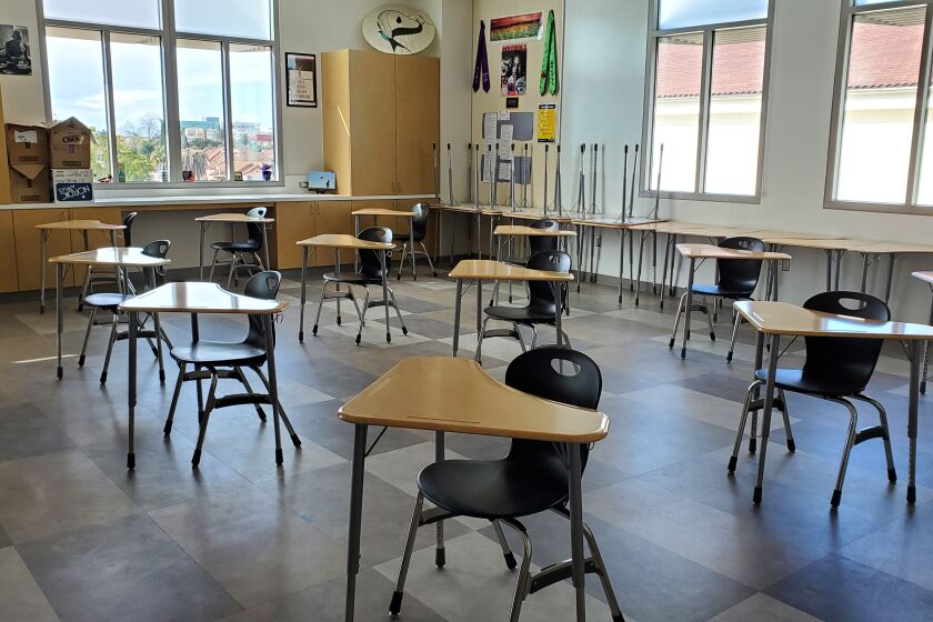 Student desks and chairs are spaced several feet apart in a classroom at Hoover High School on March 12, 2021. The newly-rebuilt school was supposed to open to students in the fall of 2020, but has yet to welcome students back because of the pandemic.