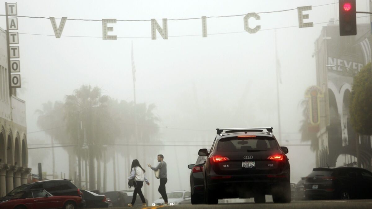 Thick fog lingering along the coast on Wednesday will blow away as Santa Ana winds make their way through the region. Here, fog blankets Venice Beach in 2017.