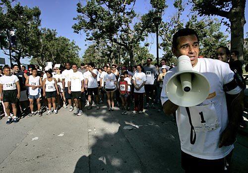 Los Angeles Mayor Antonio Villaraigosa prepares to announce the start of the Run for Victims' Rights in Exposition Park Sunday morning. The mayor also ran the 5K.