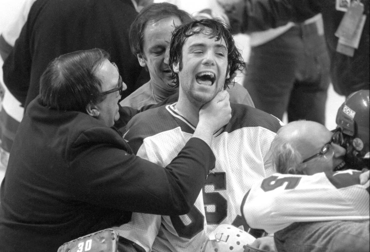 In this Feb. 22, 1980, photo, U.S. goaltender Jim Craig got a hug from goalie coach Warren Strelow after the Americans beat the Soviet Union at the Winter Olympics.