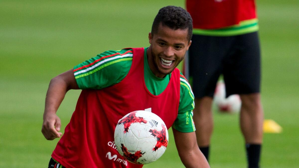Mexican soccer star Luis Hernandez heads a ball during a training
