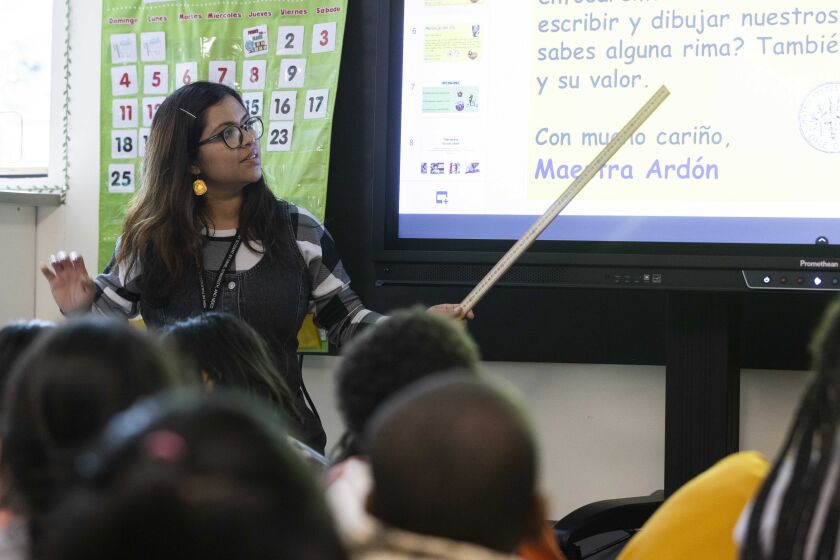 Fatima Nunez Ardon, a teacher in training, teaches Spanish to second graders at Madrona Elementary School in SeaTac, a suburb in Seattle, Wash., Wednesday, Sept. 28, 2022. Ardon went through a program at Highline College, a community college, to train to be a teacher. (Ellen M. Banner/The Seattle Times via AP)