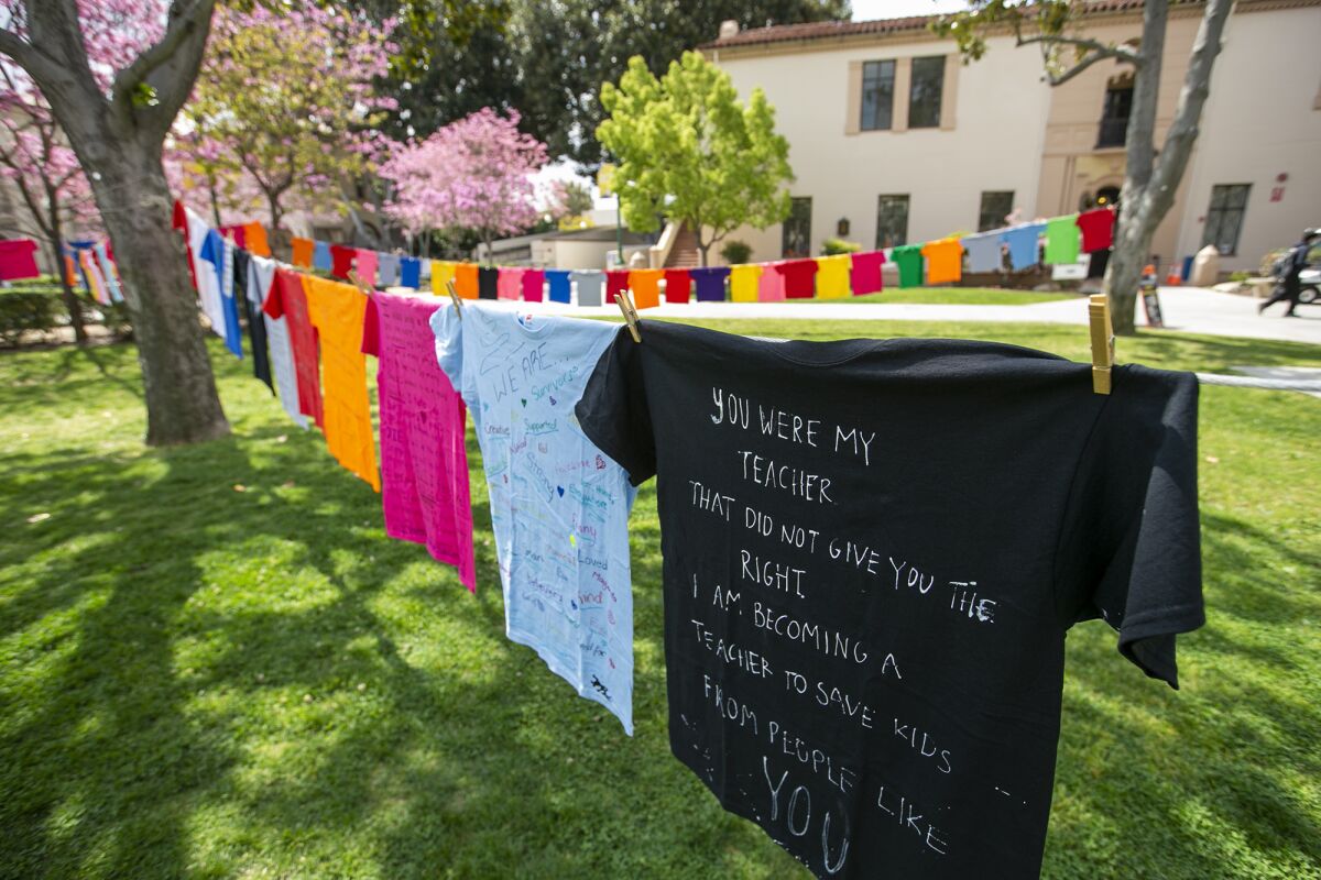 T-shirts that tell stories of sexual assault hang in the quad at Fullerton College.