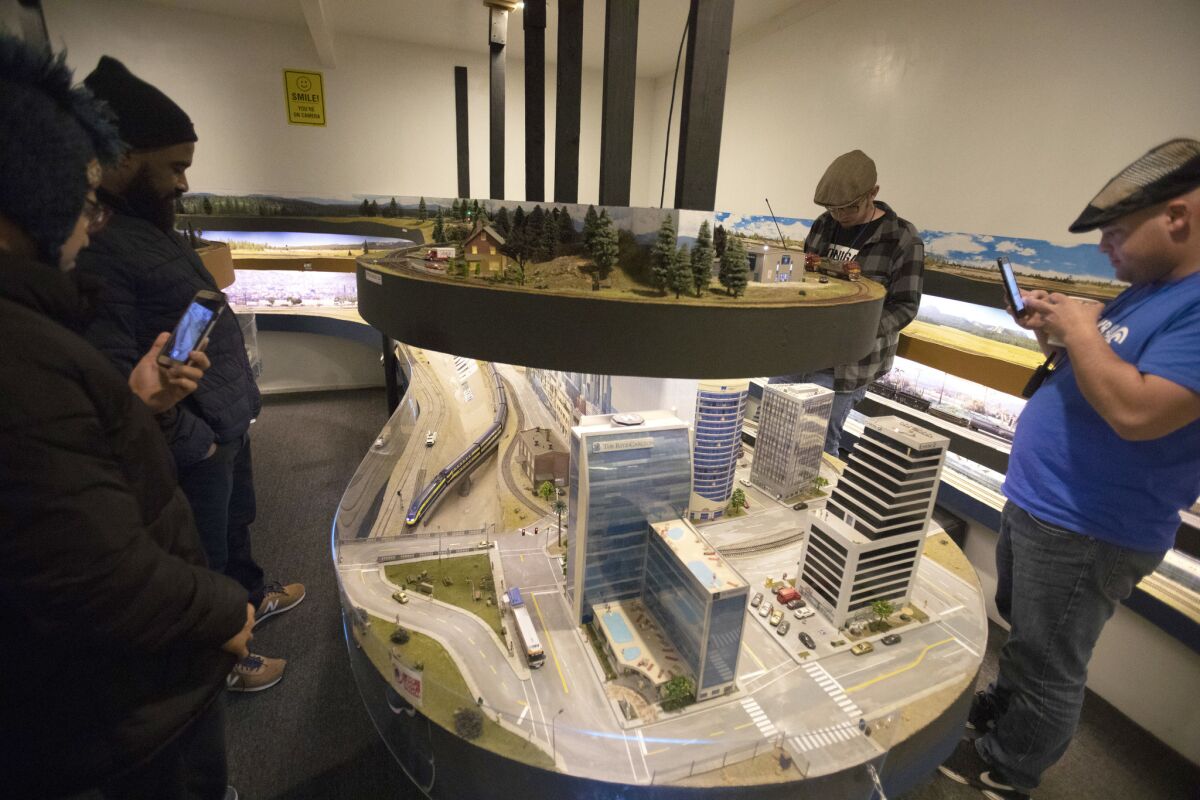 Model trains wind around 35 scale miles of track laid out in one homeowner’s garage, backyard and interior rooms. The display features Southern California locations such as downtown Los Angeles, Union Station and dozens of spots along the coast.
