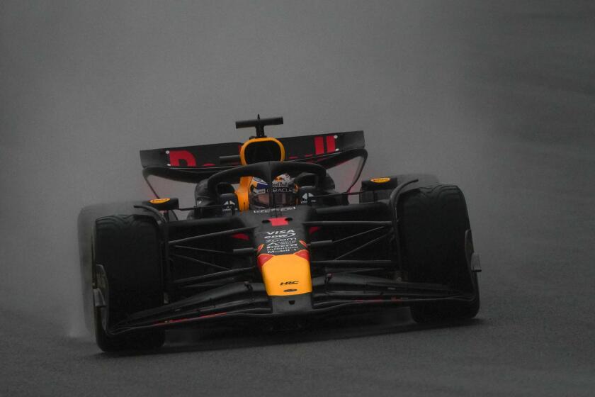 Red Bull driver Max Verstappen of the Netherlands steers his car in the rain during the sprint qualifying session for the Chinese Formula One Grand Prix at the Shanghai International Circuit, Shanghai, China, Friday, April 19, 2024. (AP Photo/Andy Wong)