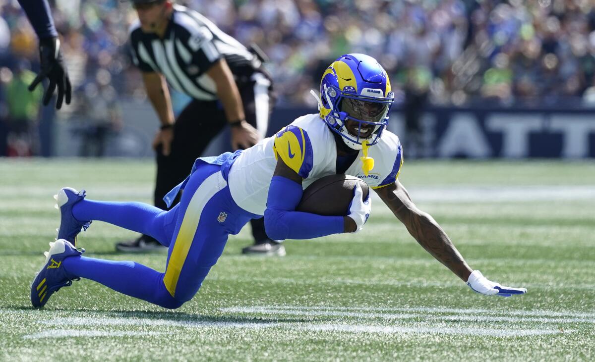 Rams receiver Tutu Atwell falls to the turf after making a reception against the Seattle Seahawks.