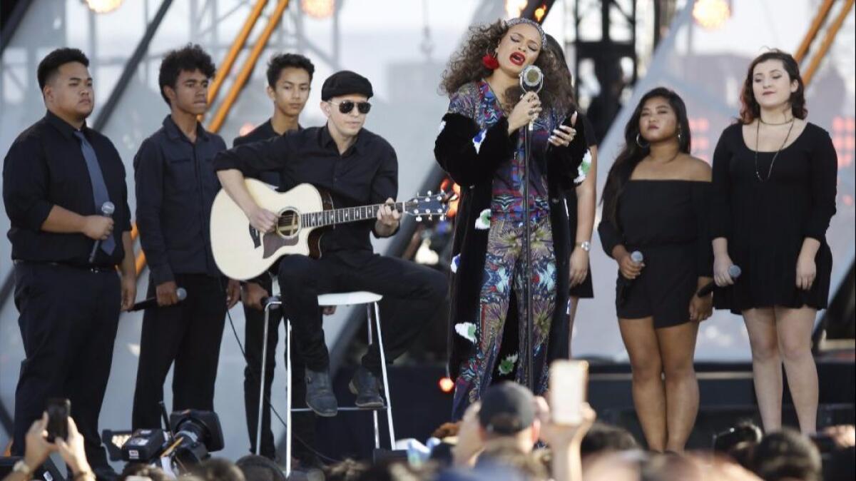 Andra Day sings her song, "Rise Up," with students from the San Diego School of Preforming Arts, at the RiseUp AS ONE concert at the U.S.-Mexico border in San Diego.