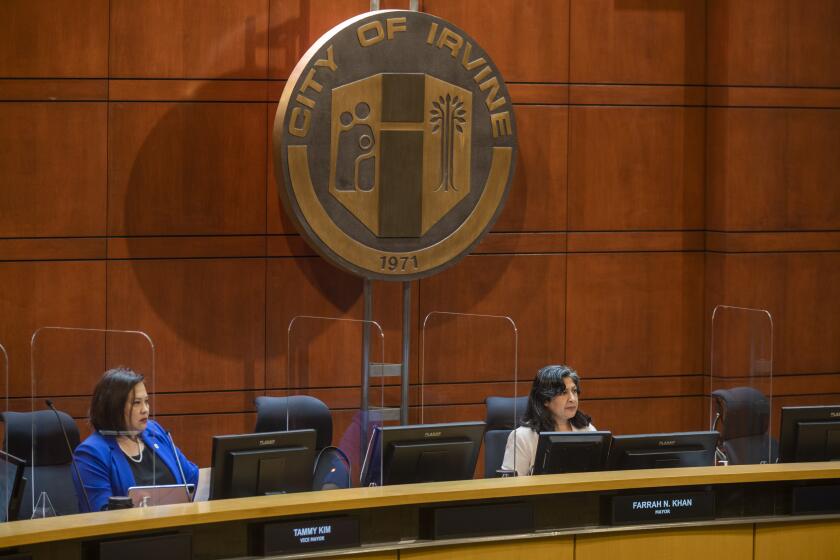 IRVINE, CA - JUNE 22: Tammy Kim Vice Mayor, left, and Farrah N. Khan Mayor, right, are participating in a Irvine City Council meeting in the Irvine City Hall Council Chambers on Tuesday, June 22, 2021 in Irvine, CA. The Irvine City Council is expected to select a site for the Veteran's Cemetery at the Great Park during its first in-person meeting in more than a year on Tuesday. Veteran's groups and residents who have been fighting to build the cemetery at the ARDA site on the former El Toro Marine Base will be showing up in significant numbers. It is expected that the council will not select the ARDA site. (Francine Orr / Los Angeles Times)