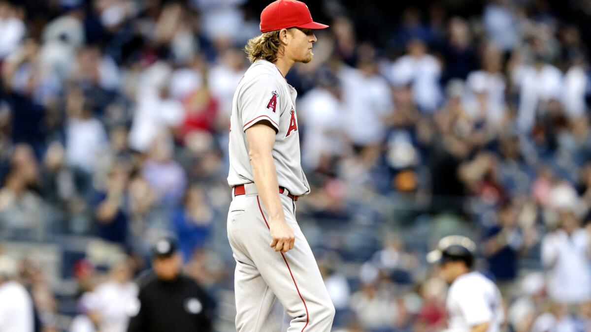 Angels starter Jered Weaver returns to the mound as Yankees infielder Stephen Drew rounds the bases after hitting a two-run home run in the second inning Friday night in New York.