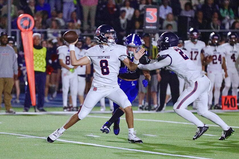 Brentwood sophomore quarterback Ben Mikail throws a pass from the pocket against Palisades.