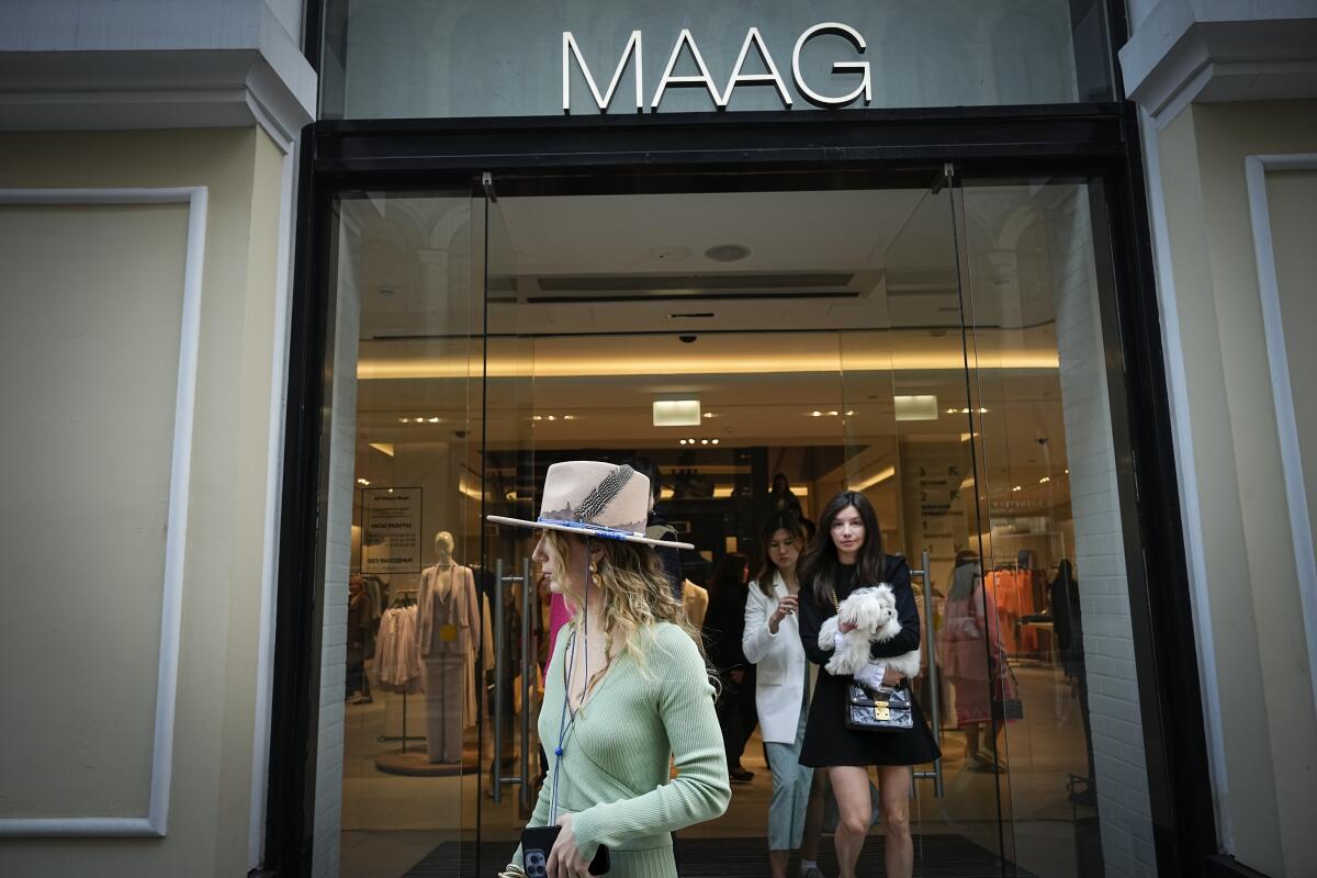 Shoppers walk out of a newly opened Maag store, formerly a Zara flagship store, in Moscow