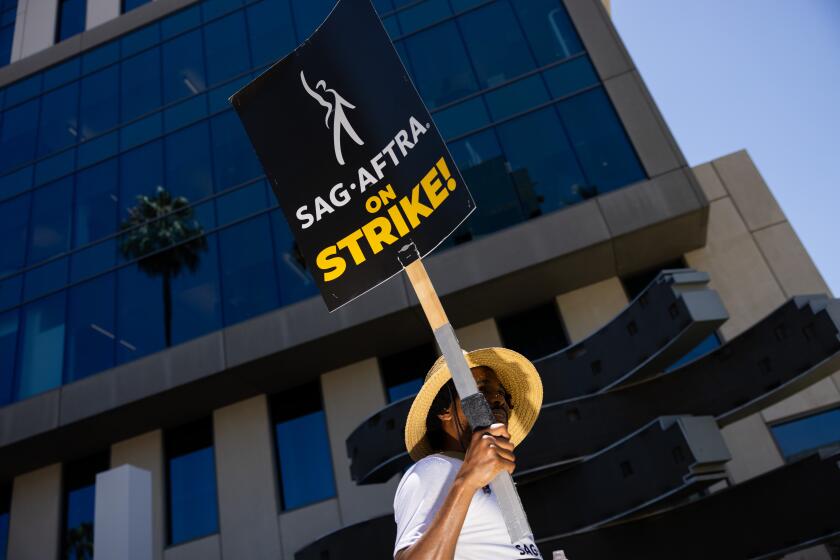 Hollywood, CA - July 26: Members of the Writers Guild of America (WGA), joined by members of the Screen Actors Guild (SAG) and American Federation of Television and Radio Artists (AFTRA), come together to picket in front of Netflix headquarters, in Hollywood, CA, Wednesday, July 26, 2023. Entertainment's largest guilds have come together, during disputed contract negotiations with the Alliance of Motion Picture and Television Producers (AMPTP).(Jay L. Clendenin / Los Angeles Times)