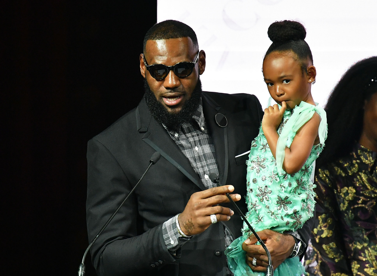 LeBron James hold his daughter, Zhuri, during a news conference at New York Fashion Week in 2018.