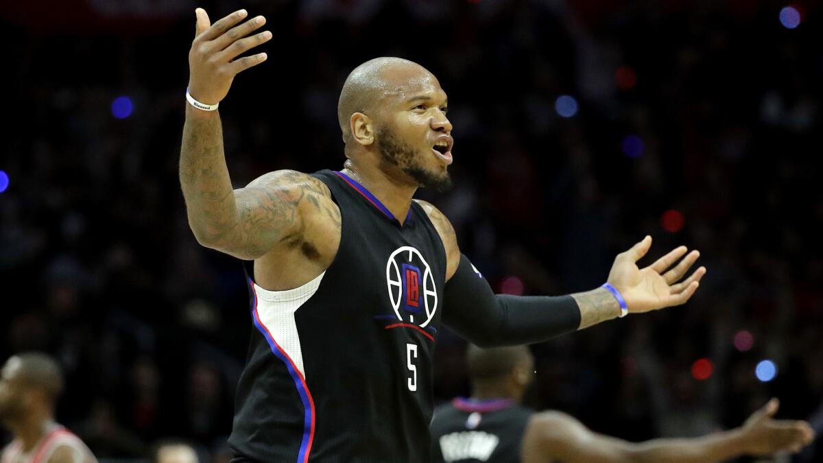 Clippers forward Marreese Speights fires up the Staples Center crowd after making a three-point shot against the Bulls during the second half Saturday.