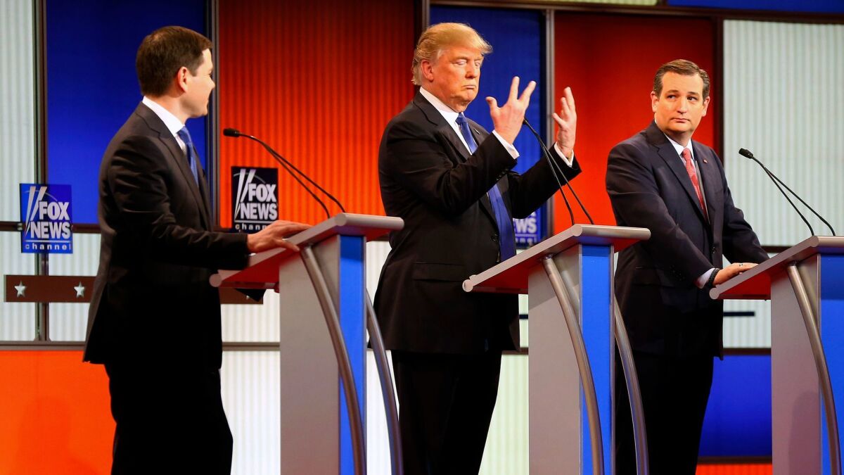 Then-presidential candidate Donald Trump gestures as Sen. Marco Rubio, R-Fla. (left) and Sen. Ted Cruz, R-Texas (right) watch him at a Republican presidential primary debate in Detroit on March 3, 2016.