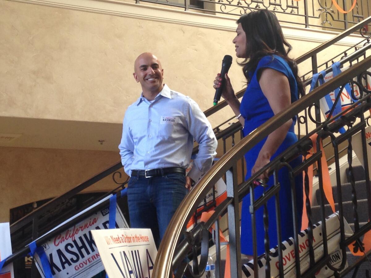 Republican gubernatorial candidate Neel Kashkari, left, listens as he is introduced by Vanila Singh, a GOP congressional candidate, at a rally Saturday.