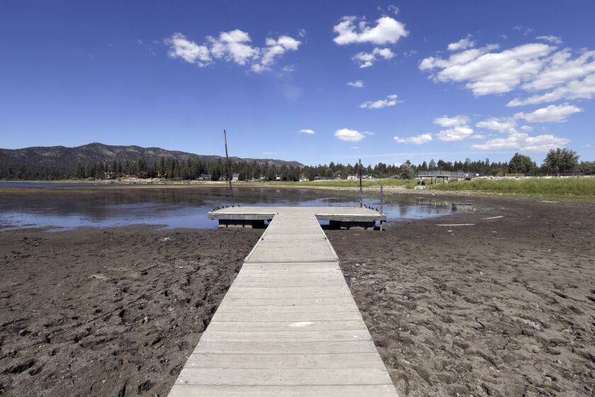 FILE - This Monday, Aug. 24, 2015 file photo shows the lake bed where water has dried due to the drought at Big Bear Lake, Calif. State officials say October’s water conservation figures for drought-stricken California are less impressive than in past months. (AP Photo/Nick Ut, File)