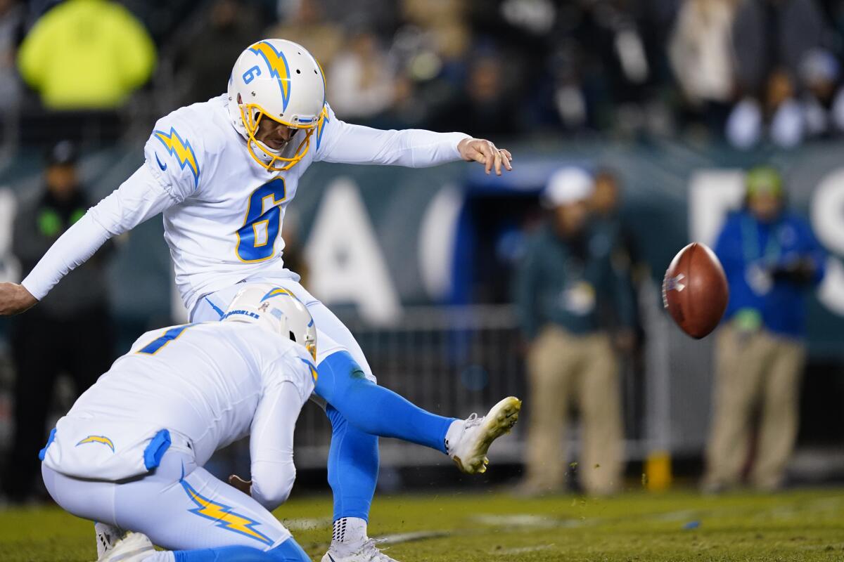 With Ty Long holding, Chargers' Dustin Hopkins kicks his game-winning field goal against the Eagles.