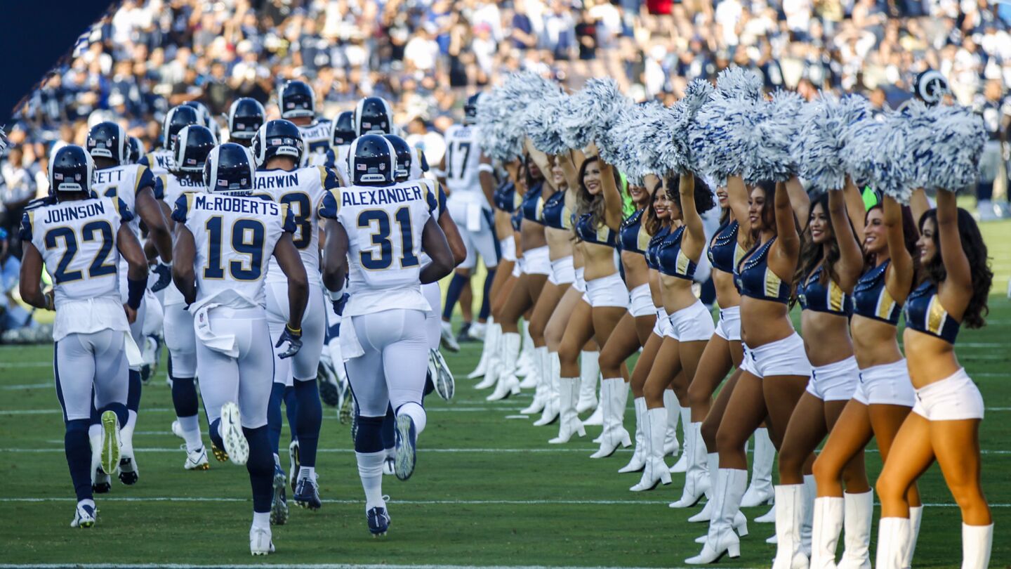 The Rams take the field for a game against the Dallas Cowboys at the Coliseum.