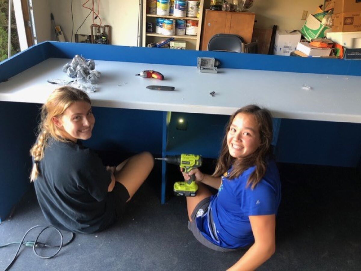 Sarah Thomton, right, built a water polo scorekeeping table as her Eagle Scout project.