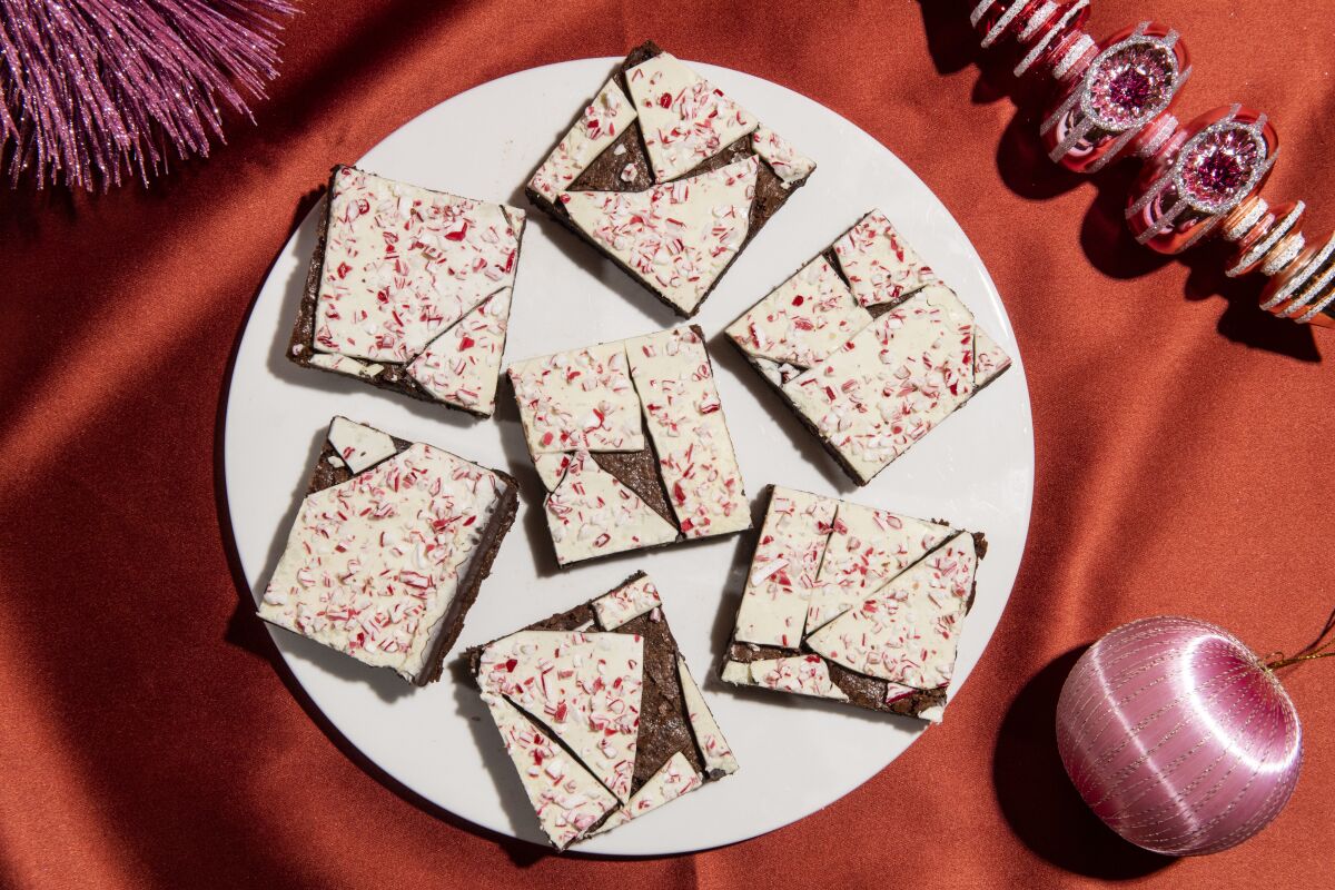 A plate of brownies topped with peppermint bark.